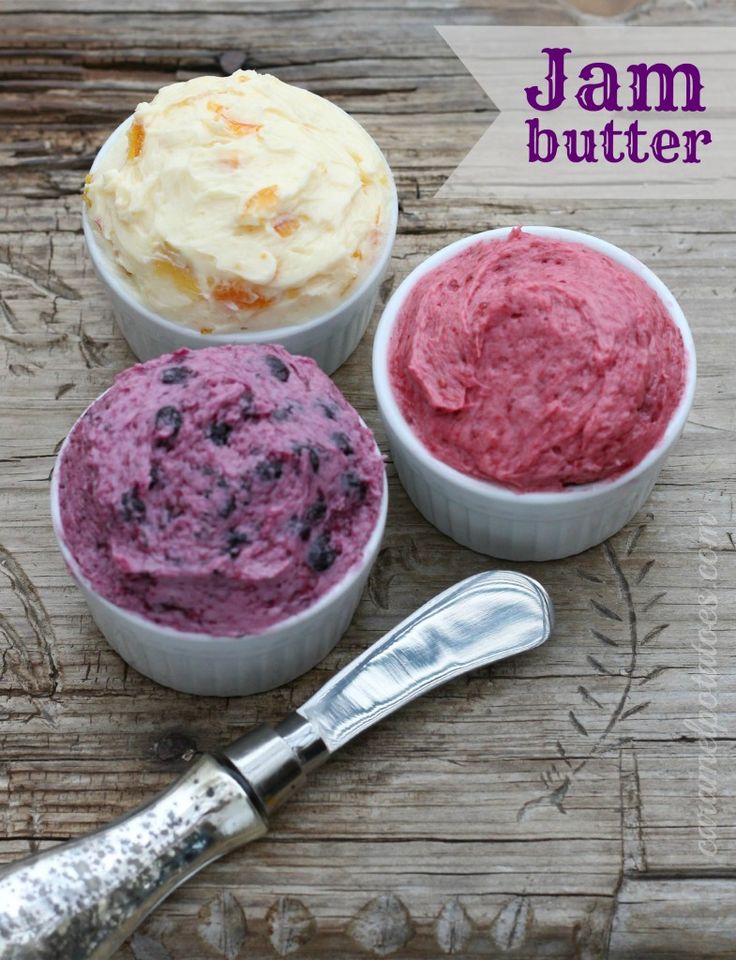 three different types of ice cream in small bowls next to a knife on a wooden table