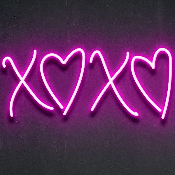 a neon sign that says xox with two hearts