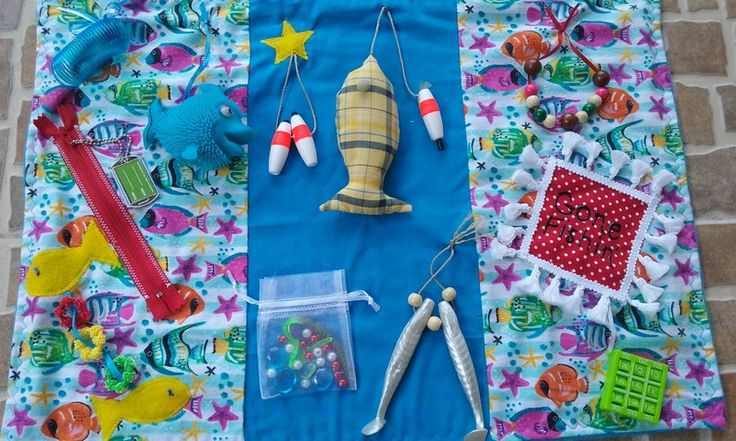 there are many different items on this colorful table cloth, including scissors and other crafting supplies