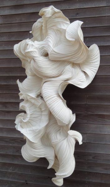 a white sculpture on the side of a building