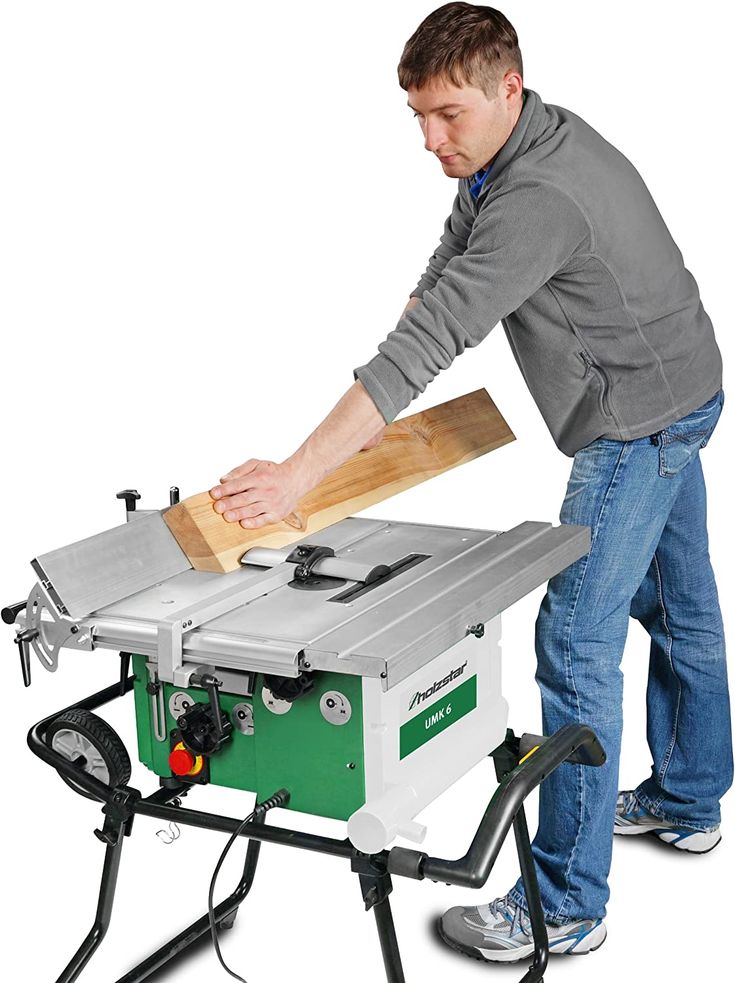 a man using a table saw to cut wood