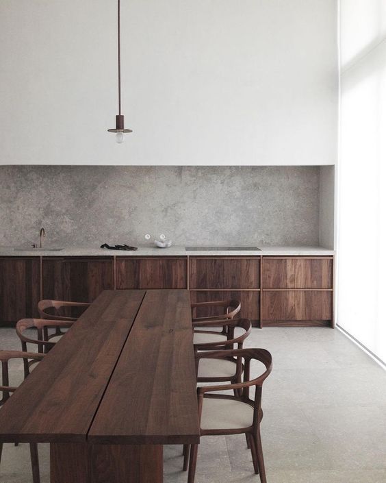 an empty kitchen with chairs and a table in front of the counter top is shown