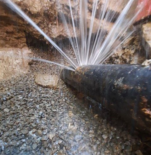 water spewing out from an old pipe