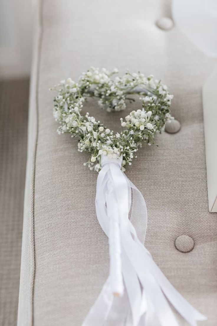 a white flower wreath on the back of a couch