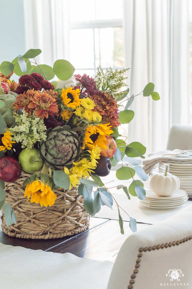 a basket filled with flowers sitting on top of a table