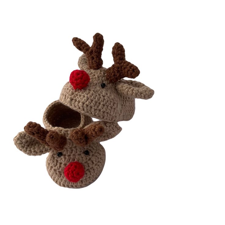 two crocheted reindeer slippers with red noses