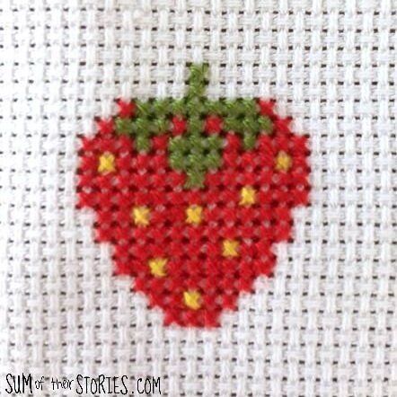 a close up of a cross stitch strawberry