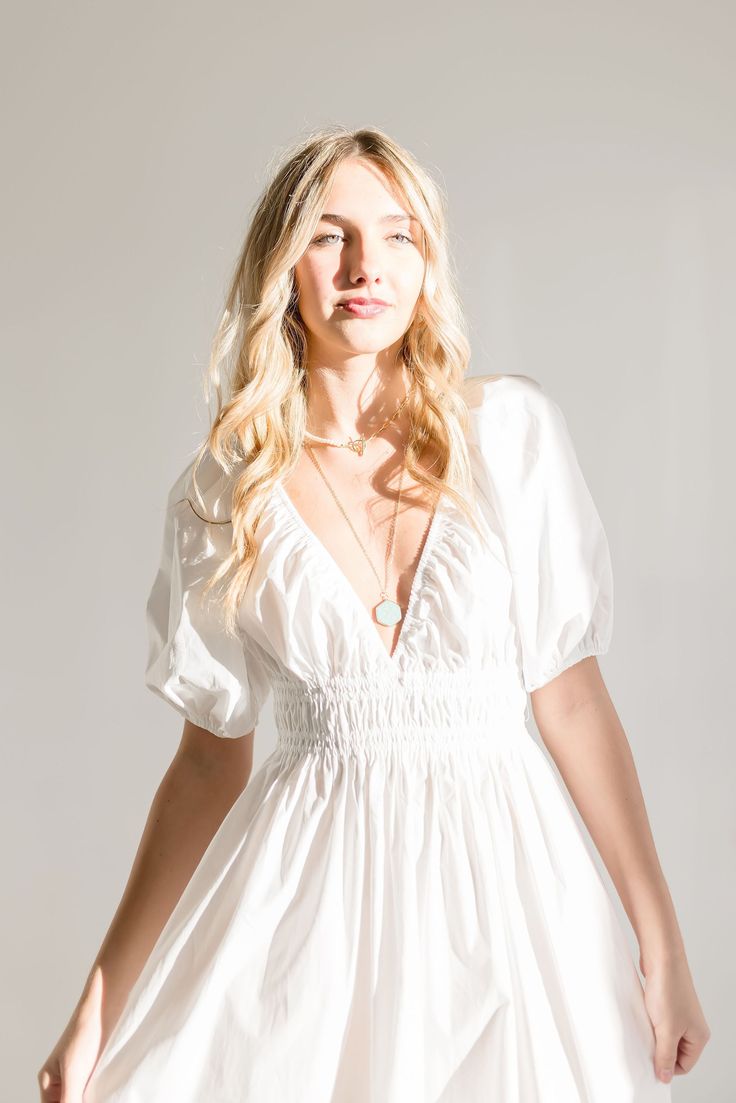 The Lou Maxi Dress brings the sass with its sweet white hue, a sultry deep V-neckline, and seriously cute 1/2 puff sleeves. The ruched waist will make you a show-stopping sensation - just pair it with some strappy heels for a brunch date look. Details+ Fit 100% Polyester Runs True to Size Hand Wash Cold Hang Dry Deep V Neckline Short 1/2 Puff Sleeves Elastic Cuffs Ruched Waist Maxi White | Solid Model is 6'1" and wearing a size Small White V-neck Puff Sleeve Dress For Summer, Chic White Mini Dress With Gathered Neckline, Feminine V-neck Mini Dress With Smocked Bodice, Fitted Puff Sleeve Dress With Smocked Bodice And V-neck, Elegant Puff Sleeve Dress With Smocked Bodice And V-neck, Chic Mini Dress With Smocked Bodice And V-neck, Elegant Mini Dress With Smocked Bodice And Short Sleeves, Chic Short Sleeve Mini Dress With Gathered Neckline, Chic Puff Sleeve Dress With Gathered Waist