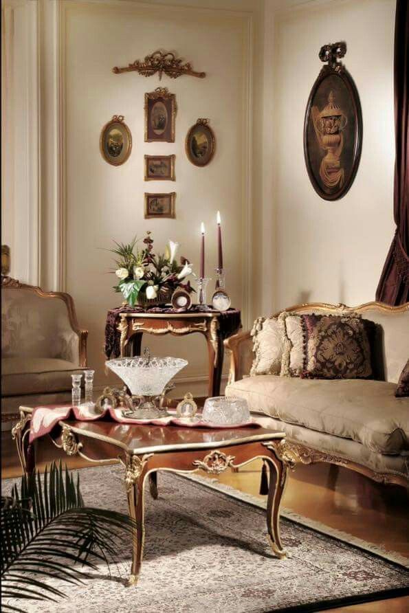 a living room filled with lots of furniture next to a wall covered in framed pictures