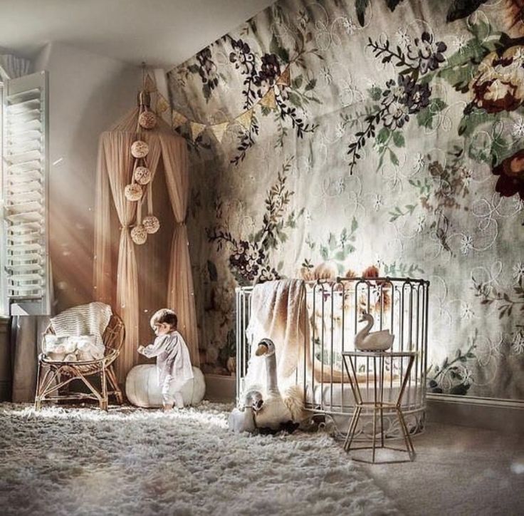 a baby's room with floral wallpaper, crib and swan bedding