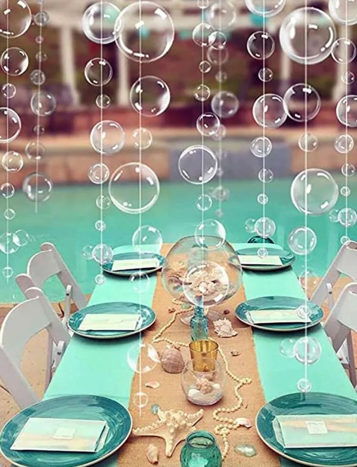 the table is set with plates, silverware and place settings for an outdoor dinner