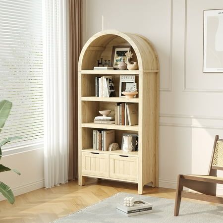 a living room with a chair and book shelf