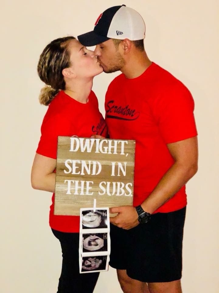 a man and woman kissing in front of a sign that says, downright send in the subs