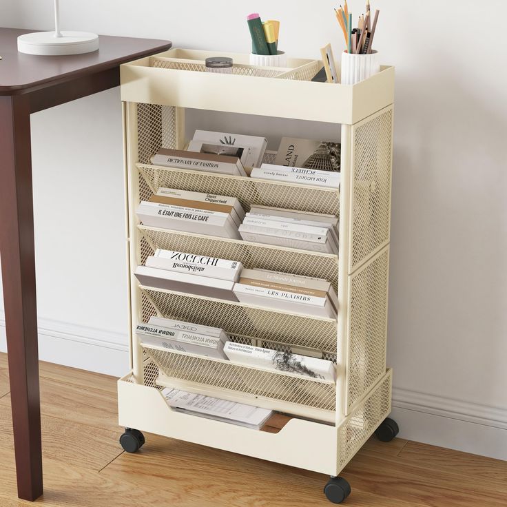 a book shelf with many books on top of it next to a table and chair