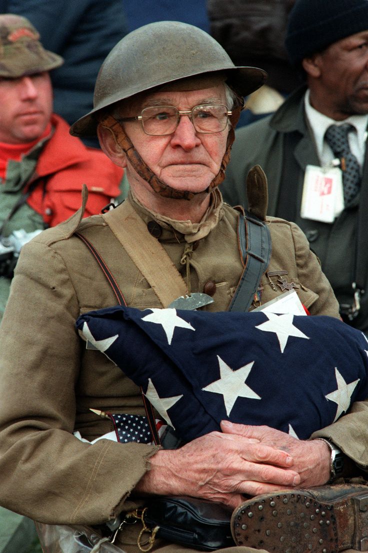 an older man in uniform holding a flag with the words thank you, veterans