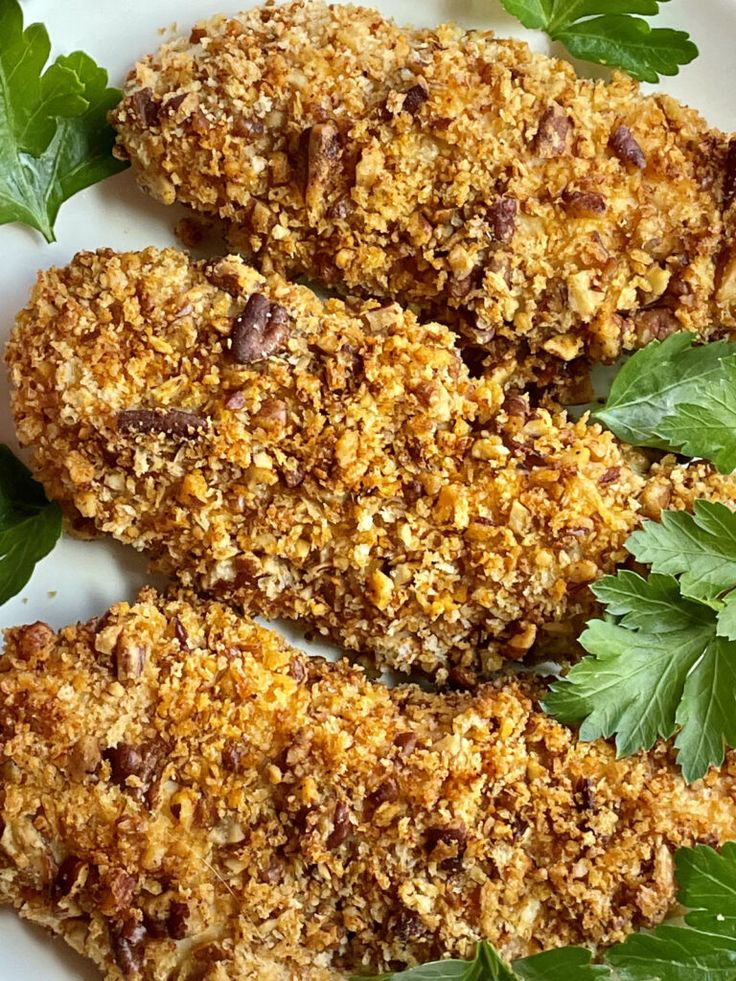 fried chicken with parsley on a white plate