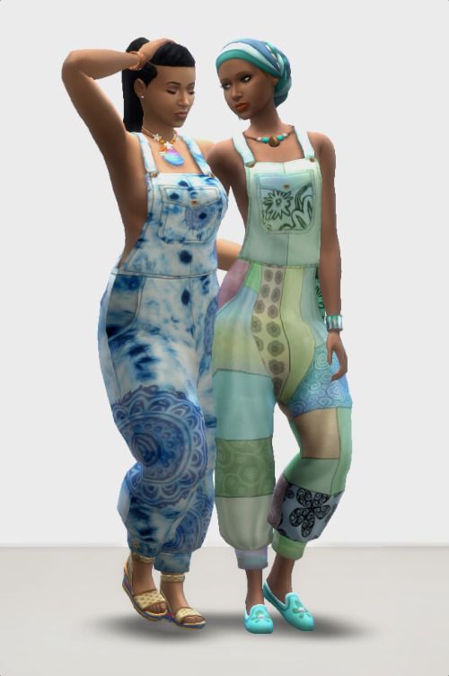 two women standing next to each other in front of a white background with blue and green designs