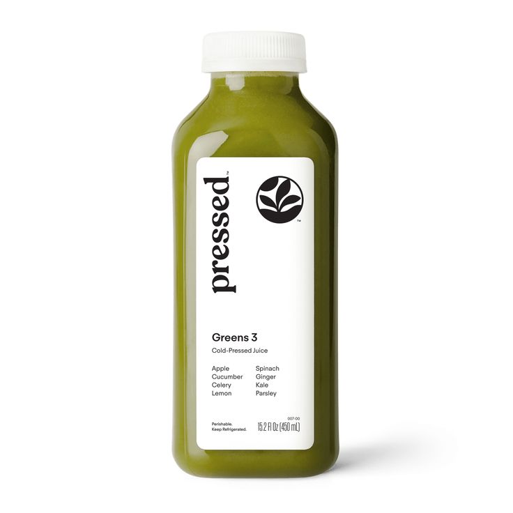 a bottle of green juice on a white background