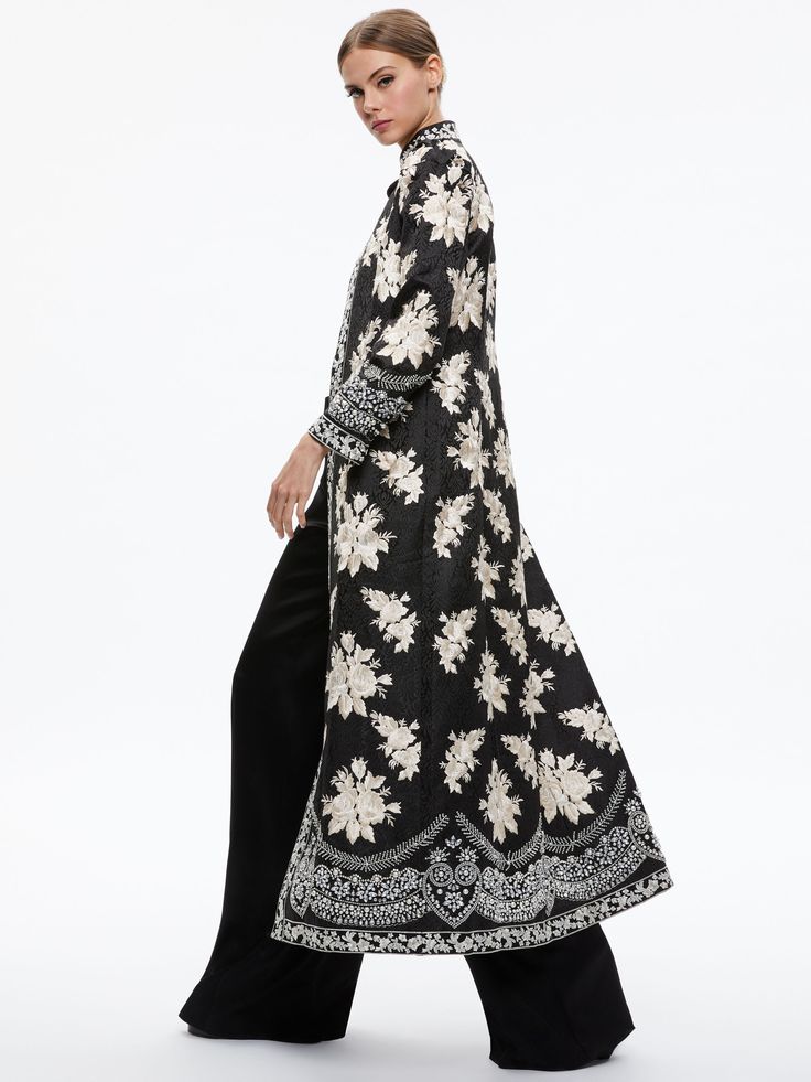 Thomas Embroidered Maxi Coat In Black/silver Spring Silk Outerwear With Resham Embroidery, Elegant Outerwear With Set-in Sleeves, Luxury Long Outerwear, Elegant Long Sleeve Abaya With Intricate Embroidery, Floral Embroidered Outerwear For Spring Evening, Spring Evening Outerwear With Floral Embroidery, Spring Floral Embroidered Evening Outerwear, Long Silk Outerwear For Fall, Fitted Long Silk Outerwear