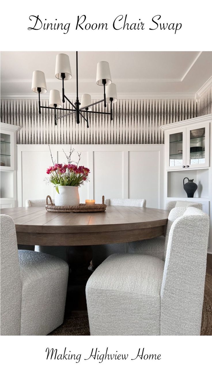 a dining room table with white chairs and a potted plant on top of it