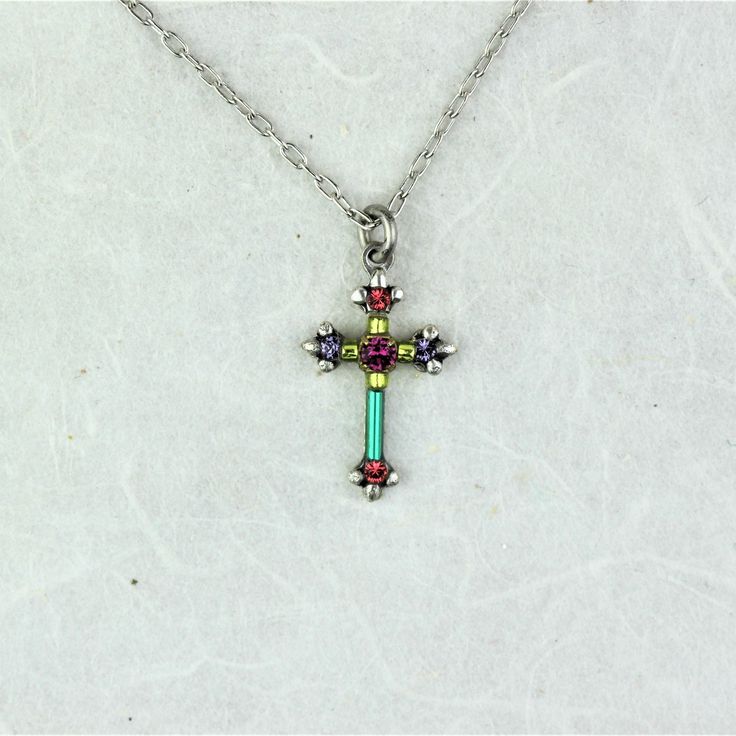 The Firefly Dainty Multicolor Cross Necklace is beautiful with the cross perched at the end of a delicate chain. This beautiful piece of jewelry is made from both Swarovski crystals and fire-polished Czech beads. The color blocking takes us back to its origins as an artisanal artwork from Guatemala. Color: Multicolor Cross is .75 inch tall Silver-plated antiqued steel Clean with a soft jewelry polishing cloth. Never clean with any chemicals, chlorine, or bleach. To avoid damaging the finish, app Spiritual Multicolor Cross Necklace, Firefly Jewelry, Soft Jewelry, Delicate Chain, Czech Beads, Polish Jewelry, Firefly, The Cross, Czech Glass Beads