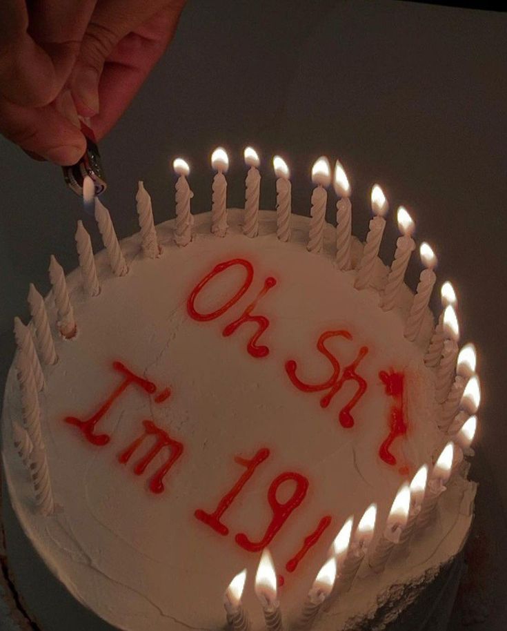 someone lighting candles on a birthday cake that says, oh stay in 19 / 9