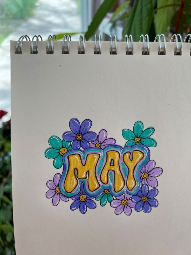 a notepad with the word may painted on it