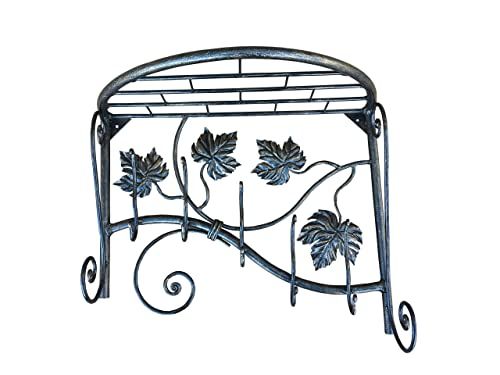 a wrought iron shelf with leaves on it