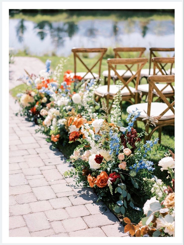 rows of chairs lined up with flowers and greenery