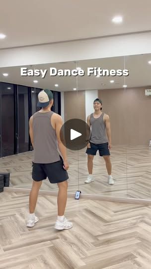 two men are doing exercises in an empty dance fitness room with mirrors on the wall