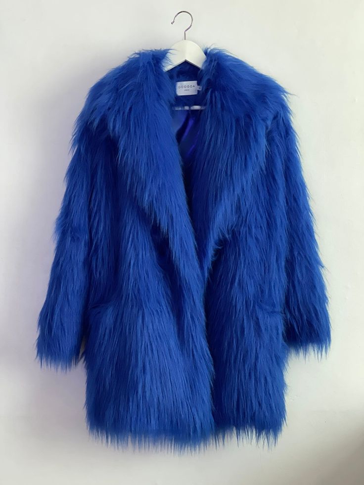 "Deep Electric Blue Oversize Fur Coat. Luxury, fluffy fabric, very soft. 100% polyester. Handmade made in London, UK.  Oversize style. Big collar. Long sleeves. Metal snap buttons (invisible) Two side pockets. Lenght 82cm - 1cm) Handmade in UK.  Model wears size S.  HOW TO CHOOSE A SIZE ?   Using a measuring tape, measure your bust, waist and hips (widest part) and compere with size chart.  SIZE CHART: (CM) B: Bust  H: Hips  XS - B: 83-88 cm  H: 90-95 cm  S - B: 88-93 cm H: 95-100 cm  M - B: 93-98 cm H: 100-105 L - B: 103-108 cm  H: 105-110 cm XL - B: 108-113 cm H: 110-115 cm CARE INSTRUCTIONS: Dry clean only, do not wash, do not iron, do not bleach.  Please message me before purchasing so I can check availability. If you wish this fur in any other colour, shorter or longer \"send message Blue Fur Jacket, Shaggy Fur Coat, Oversized Fur Coat, Blue Fur Coat, Blue Faux Fur Coat, Royal Blue Jacket, Shaggy Jacket, Oversize Coat, Rabbit Fur Jacket