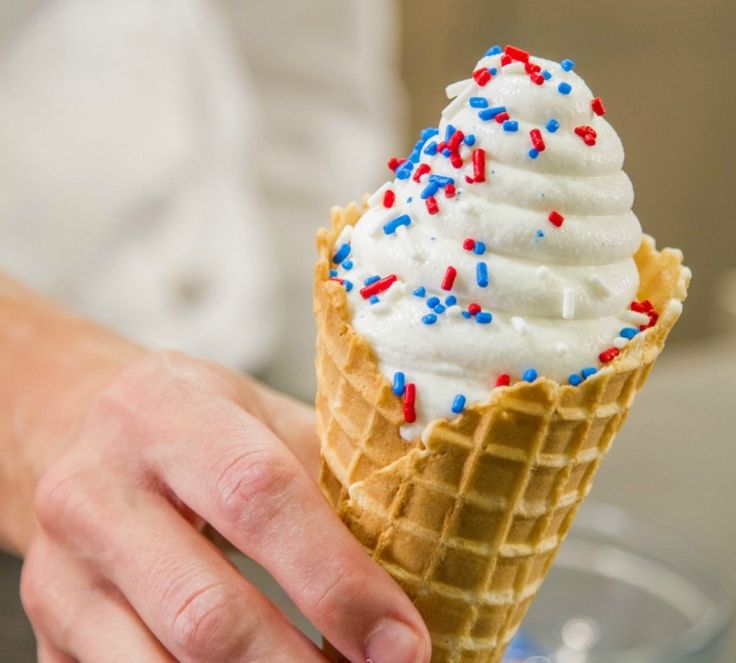 an ice cream cone with red, white and blue sprinkles on it