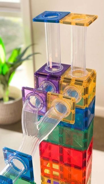 a stack of colorful plastic blocks sitting on top of a table