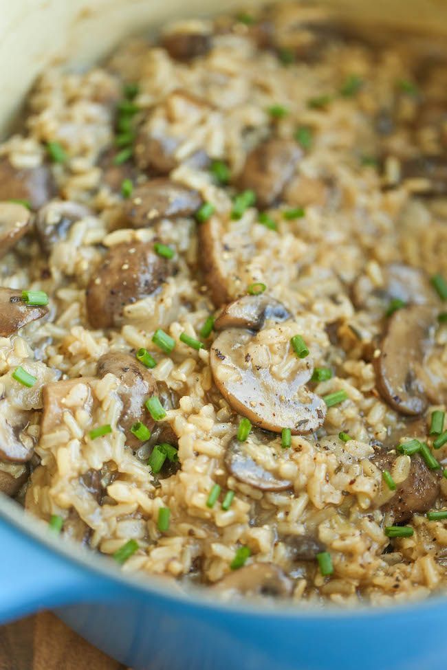 a blue pot filled with rice and mushrooms