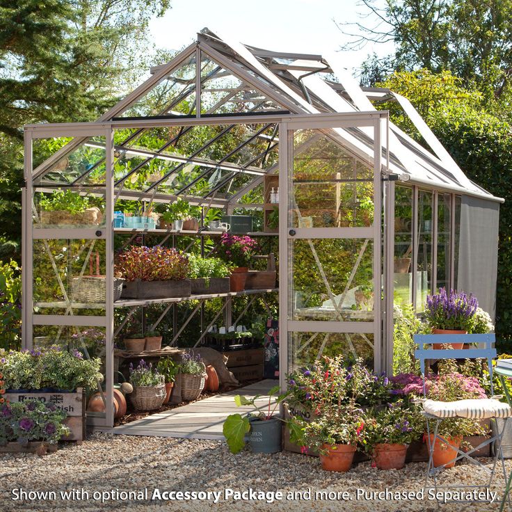 a small greenhouse with potted plants in it