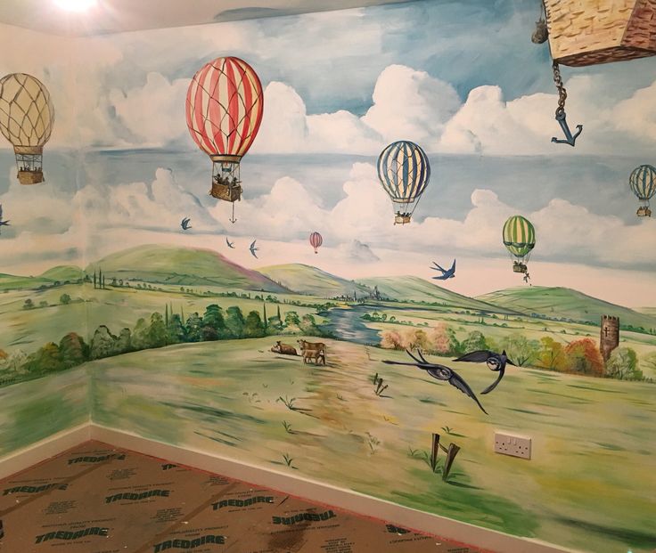 a mural in the corner of a room with hot air balloons