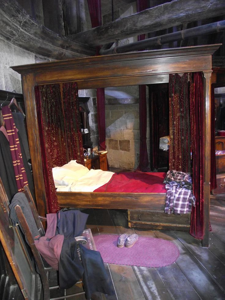 a bed sitting inside of a wooden frame on top of a floor next to a chair