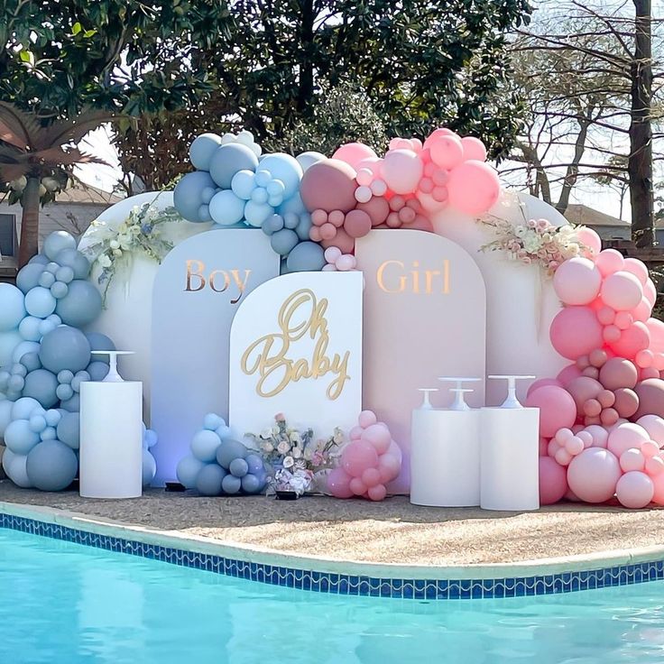 a pool party with balloons, candles and decorations