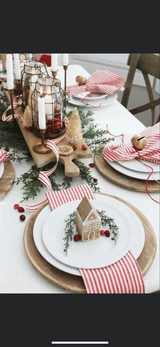 a table set for christmas with plates and candles