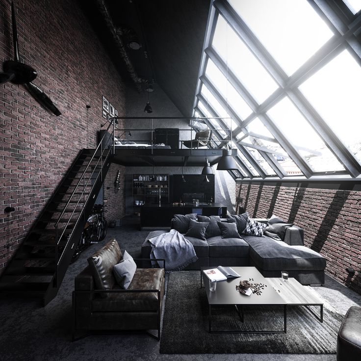 a living room filled with lots of furniture next to a loft type building wall covered in windows