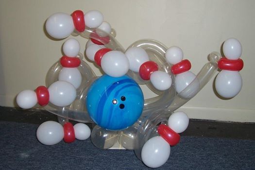 an inflatable bowling ball with red, white and blue balls attached to it