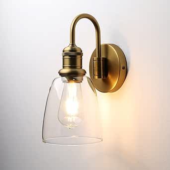 a wall light with a clear glass shade