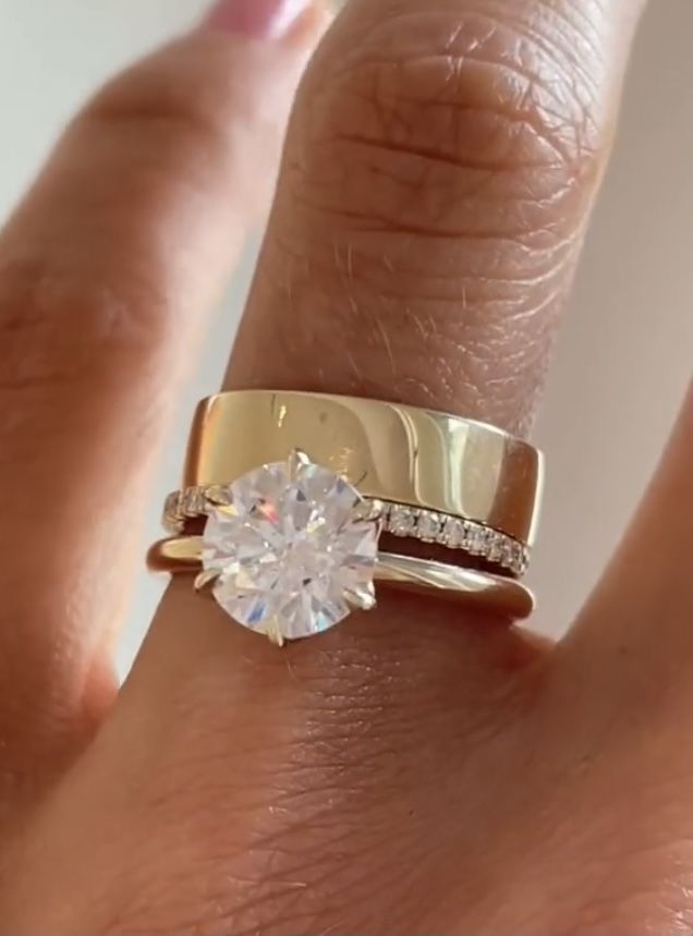 a woman's hand with a ring on it and a diamond in the middle