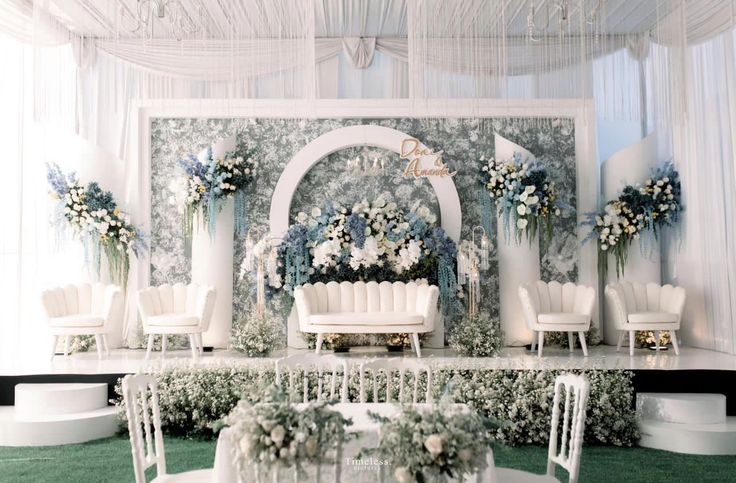 a wedding ceremony setup with white chairs and flowers