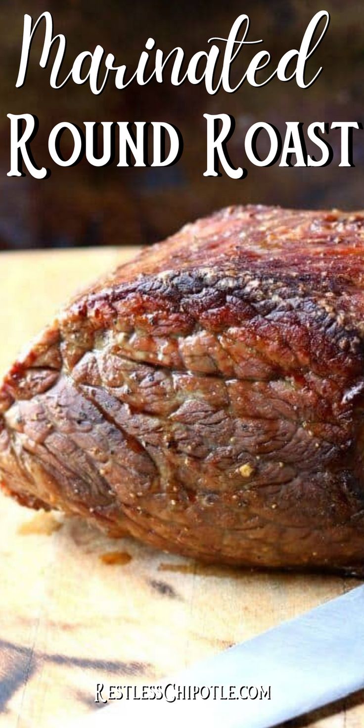 a piece of meat sitting on top of a cutting board next to a knife