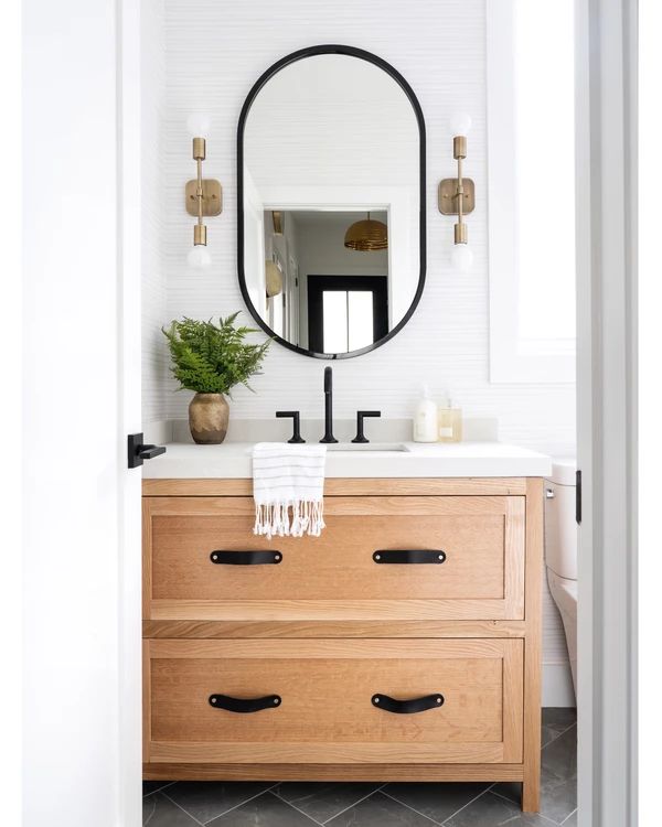 the instagram page shows an image of a bathroom vanity with a mirror above it