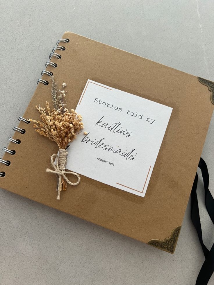 a note book with dried flowers tied to it