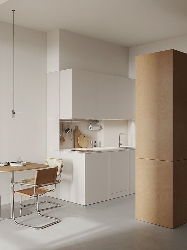 a kitchen with white walls and flooring next to a dining table in front of an oven