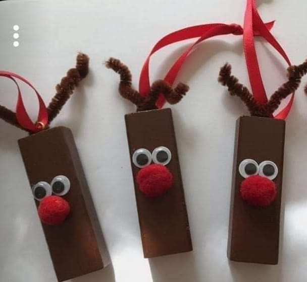 three brown paper bags decorated with reindeer noses