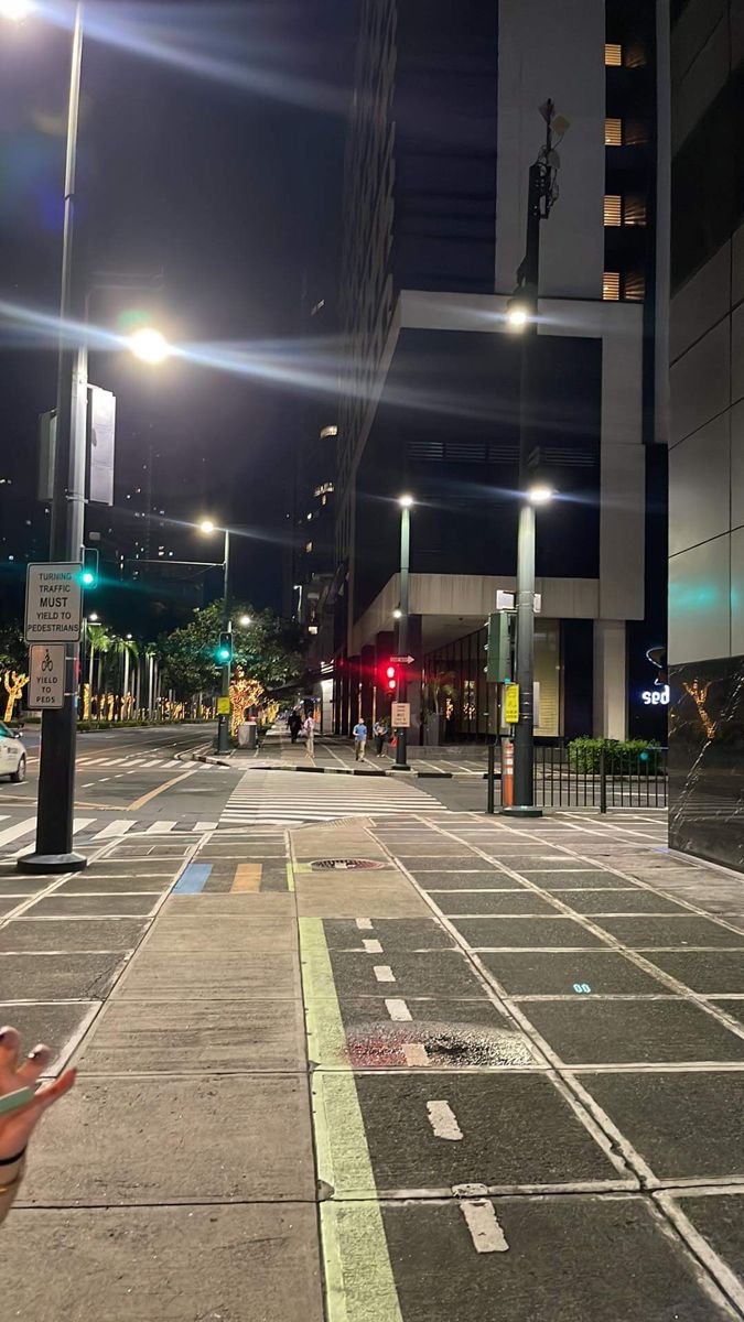 an empty city street at night with traffic lights